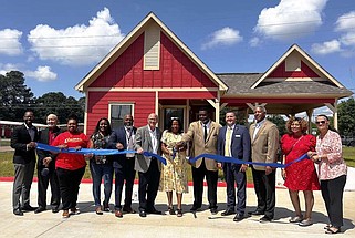 City officials and others participate in the ribbon-cutting ceremony for The Cottages at Midway on Tuesday, April 30, 2024, in Texarkana, Texas. The senior-friendly cottages at North Robinson Roads and Rose Hill Driv, are designed exclusively for people age 60 and older. (Staff photo by Sharda James)